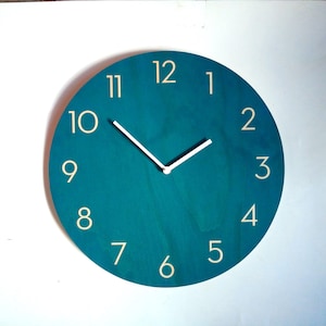 Teal Wooden Wall Clock With Neutra Numbers. Unique colourful mid century modern silent analog clock for the kitchen, living room or bedroom.