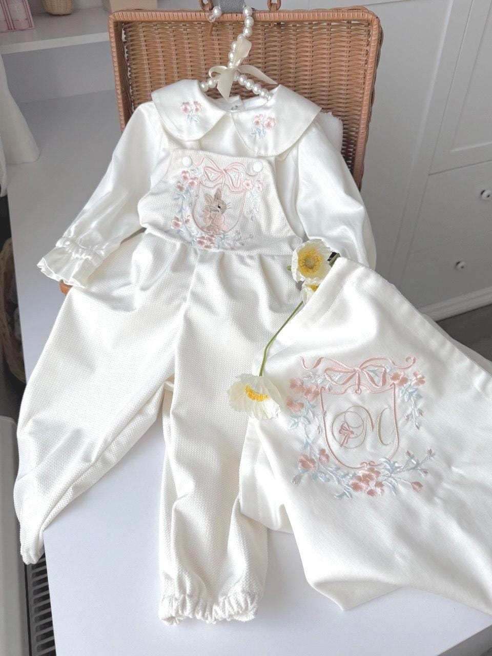 Embroidered floral clothing set for a newborn girl. Romper + shirt.