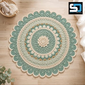 May include: A round, crocheted rug featuring a central floral motif surrounded by concentric rings of sage green, cream, and tan yarn. The edge is finished with a scalloped border. A small stuffed rabbit toy sits in a basket nearby.