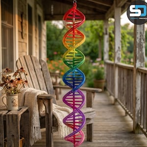 May include: A hanging wind spinner featuring a vertical, spiraling DNA double helix structure. The object displays a vibrant rainbow gradient, transitioning from red at the top through orange, yellow, green, blue, and violet to pink at the base.