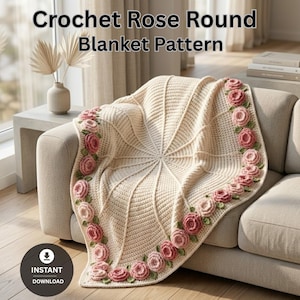 May include: Cream-colored crochet blanket with a rose pattern border. The blanket is draped over a beige sofa. The border features pink and green crochet roses. The text "Crochet Rose Round Blanket Pattern" is at the top of the image.