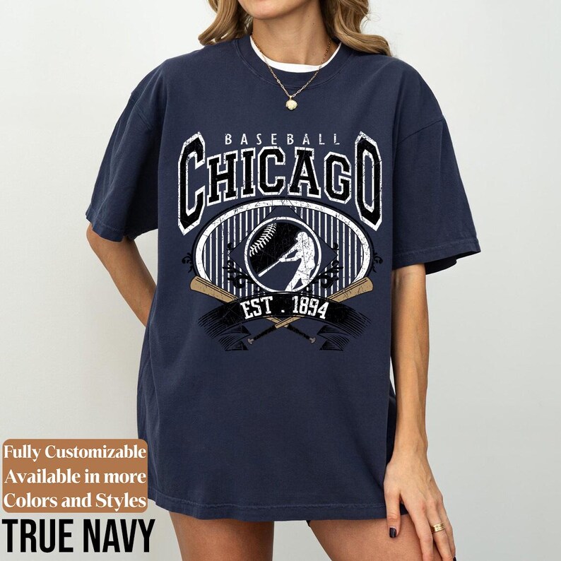 May include: Navy blue baseball-themed t-shirt with the text "CHICAGO" in a bold, vintage font. The design includes a baseball, a batter silhouette, and the text "EST. 1894". The shirt is labeled "TRUE NAVY" and is fully customizable.