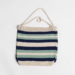 May include: A striped knitted tote bag with a cream, blue, and green color scheme. The bag has a single strap.