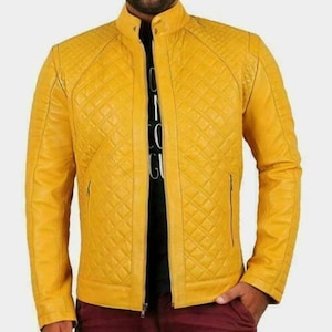 May include: A vibrant yellow quilted leather jacket with a stand-up collar and a full-length zip. The jacket features a diamond pattern and two side pockets. The person is wearing a black shirt underneath.