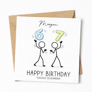 May include: A birthday card with a brown envelope. The white card features stick figures juggling the numbers 6 and 7. The words "Happy Birthday" are below the figures, with the name "Morgan" above. The text "SIXxxxxx SEVENnnnnn" is at the bottom.