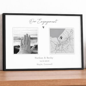 May include: Black framed print with two black and white photos. One shows a hand with a ring, the other a map. Text reads "Our Engagement", names, date, and location: Hayle, Cornwall.