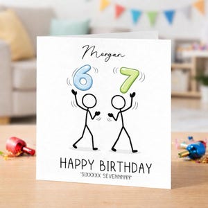 May include: A white birthday card with the name "Morgan" in cursive script. Two stick figures are juggling the numbers 6 and 7. The words "HAPPY BIRTHDAY" are printed below, with "SIXXXXX SEVENNNNN" below that.