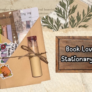 May include: A stationery set for book lovers, featuring a kraft paper envelope tied with twine. Inside are pens, bookmarks, and stickers. A wooden sign displays "Book Lover Stationary Set".