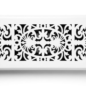 May include: A rectangular white vent cover with a decorative black filigree design. The design features an oval center with symmetrical floral and scroll patterns, and repeating patterns on each side.