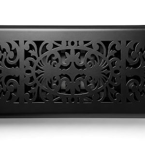 May include: A rectangular floor register vent cover with a matte black finish. The metal surface features an intricate, symmetrical laser-cut scrollwork pattern consisting of swirling filigree designs and a central oval motif for airflow.