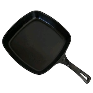 May include: Black cast iron square skillet with a long handle. The skillet has rounded corners and a flat cooking surface. The handle has a hole for hanging. This cookware is ideal for stovetop or oven use.