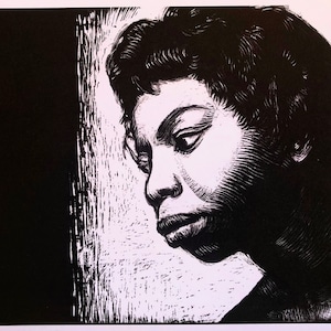 May include: A black and white linocut print of a person in profile, gazing downward. The artwork features detailed cross-hatching and shading, creating a dramatic contrast between light and shadow. The person has short, curly hair and a contemplative expression.