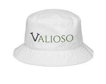May include: White bucket hat with the word "VALIOSO" embroidered in green and dark blue. The hat has a rounded crown and a downward-sloping brim. The hat is made of a soft, textured fabric.
