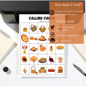 May include: A printed sheet with the words "CALLING CARDS" and instructions for use. The sheet features a grid of colorful illustrations of fall-themed items like pumpkins, pies, and turkeys. A printer and pen are visible in the background.