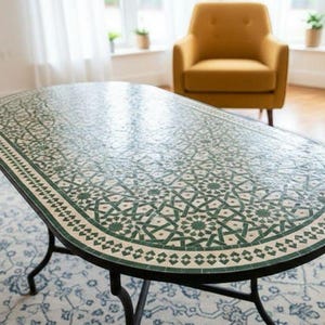 May include: Oval coffee table with a mosaic tile top featuring a green and white geometric pattern. The table has a black metal base with curved legs. The table is approximately 152 cm long and 76 cm wide.