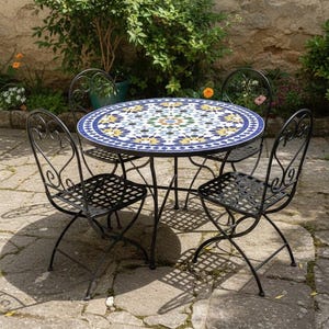 May include: A garden dining set featuring a round table with a mosaic tile top and four black wrought iron chairs. The table has a blue border and a colourful geometric pattern. Chairs have decorative backs.