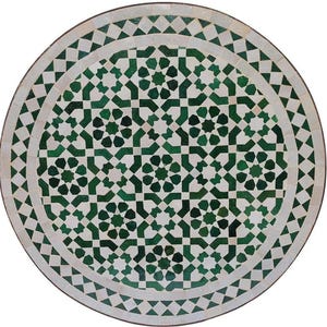 May include: Circular mosaic table with a detailed geometric pattern in green and white. The table has a central starburst design and intricate borders. The mosaic is set against a dark brown frame. The table's diameter is approximately 100 cm.