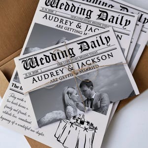 May include: Wedding Daily newspaper-style wedding invitations. The headline reads "Audrey & Jackson are getting married." Includes a black and white photo of the couple and a drawing of a table setting. Tied with twine, the invitations are in a brown envelope.