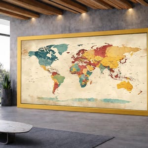 May include: A large, framed world map with a gold-colored frame. The map features a vintage aesthetic with a cream-colored background and colorful continents. The map is displayed in a modern room with a large window and a gray rug.