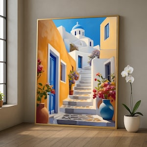 May include: A framed painting of a Santorini street scene. The artwork shows white buildings with blue doors and a blue-domed church. A staircase leads upwards, and colourful flowers in terracotta and blue vases add vibrancy to the scene. The frame is gold.
