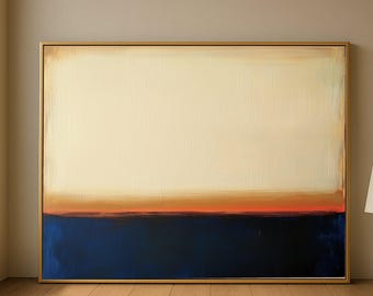 May include: Abstract painting with a gold frame. The artwork features a cream-colored upper section, a band of orange and brown in the middle, and a deep blue lower section. The painting is displayed on a wooden floor.