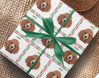 May include: White wrapping paper featuring a repeating pattern of a brown poodle illustration with the name "BORIS" and red and green polka dots. A dark green ribbon is tied around the gift. The text "Personalize it with your favorite dog breed" is visible.
