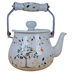 May include: White enamel teapot with a floral design. The teapot features a tree with red fruit, yellow flowers, and a butterfly. The handle and lid knob are white, and the handle has a floral pattern.