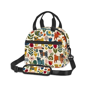 May include: A lunch bag with a cream background featuring a repeating pattern of pugs in various colors, including tan, black, and brown, interspersed with colorful stylized flowers, leaves, and abstract shapes. It has black handles and a shoulder strap.