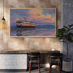 May include: A framed art print depicts a train reflected in water under a sunset sky. The train is cream and maroon, set against a backdrop of pink, orange, and blue clouds. The artwork is displayed above a wooden desk with two chairs.