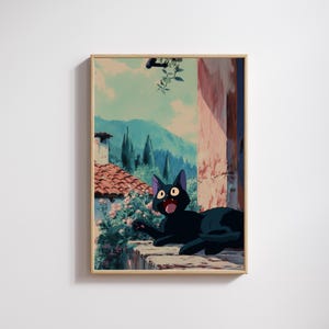 May include: A framed print featuring a black cat with wide eyes and an open mouth, set against a backdrop of a scenic Italian landscape. The artwork showcases a terracotta roof, lush greenery, and distant mountains under a blue sky.