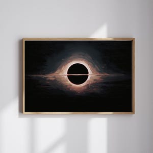 May include: Abstract art print featuring a black hole illustration. The artwork depicts a dark, circular void with a bright, glowing halo effect. The image is framed in a natural wood frame, adding a touch of warmth to the cosmic scene.