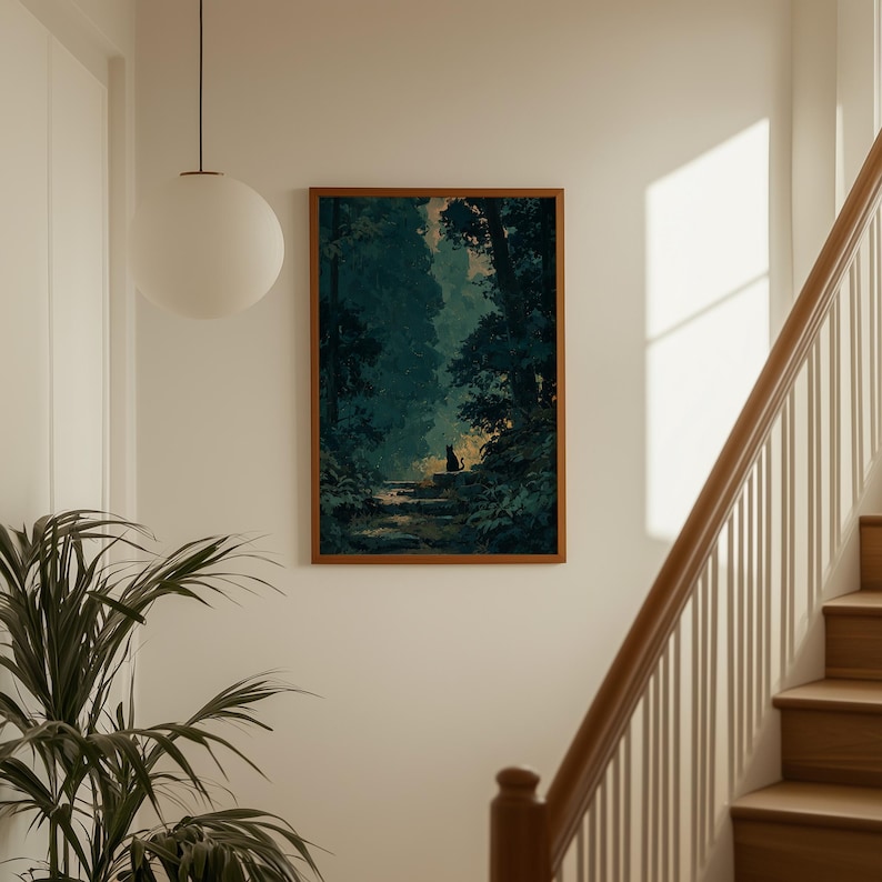 May include: A framed art print depicts a serene forest scene with a pathway leading to a clearing. The artwork features a black cat silhouette on the path, surrounded by lush greenery and tall trees. The frame is a warm brown color, adding to the artwork's natural aesthetic.