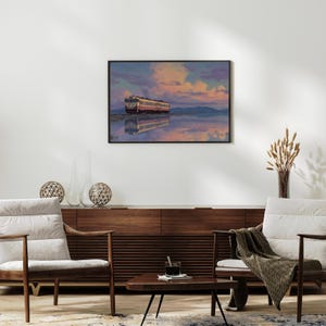 May include: A framed art print depicts a train reflected in calm water under a colorful sky. The train is white and red, set against a backdrop of pink, purple, and blue clouds. The artwork is displayed above a mid-century modern style wooden cabinet.