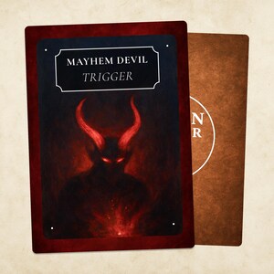 May include: Two playing cards. The front card has a dark red border and a black background with a red devil illustration and the text "MAYHEM DEVIL TRIGGER". The back card is brown with a white circular design.