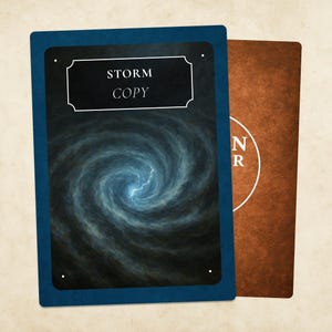 May include: Two playing cards. The front card has a dark blue border and features a swirling blue and gray storm graphic with a lightning bolt. The text "STORM COPY" is in a white frame. The back card is brown with white text.