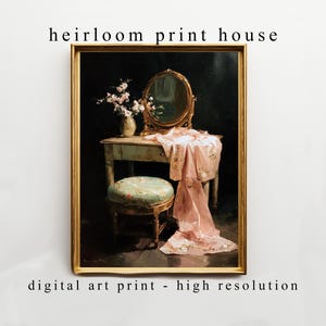 May include: A framed digital art print featuring a vintage vanity scene. The artwork depicts a vanity table with a mirror, a pink floral scarf, a vase of flowers, and a small stool. The text "heirloom print house" and "digital art print - high resolution" are visible.