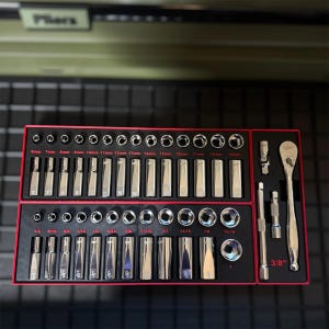 May include: A set of chrome sockets and ratchets arranged in a red tray. The sockets are labeled with both metric and imperial measurements, including sizes like 6mm, 1/4 inch, and 3/8 inch. The set includes a ratchet wrench.