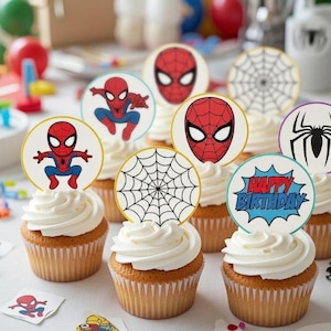 May include: Cupcakes with white frosting and Spiderman-themed toppers. The toppers feature Spiderman's face, a spider web, and the words "Happy Birthday". The cupcakes are in brown paper liners.