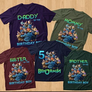 May include: Five short-sleeved t-shirts in various colors, including purple, green, and burgundy. Each shirt features a cartoon graphic of animal characters and text such as "Daddy", "Mommy", "Sister", "Brother", and "Benjamin".