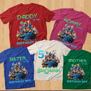 May include: Five colorful t-shirts with birthday-themed graphics. The shirts are red, pink, blue, white, and green. Each shirt has a cartoon graphic and text that reads "Daddy", "Mommy", "Sister", "5 Benjamin", and "Brother" with "Birthday Boy".