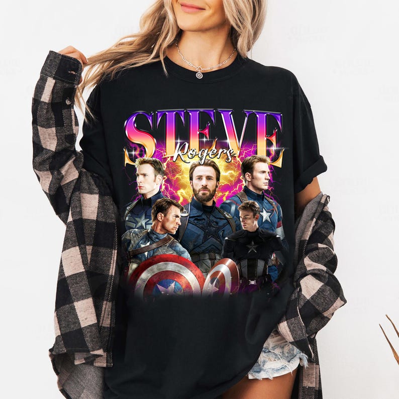May include: Black t-shirt featuring a graphic of Steve Rogers from the Captain America movies. The design includes multiple images of the character, the name "Steve Rogers" in a colorful, stylized font, and the Captain America shield.