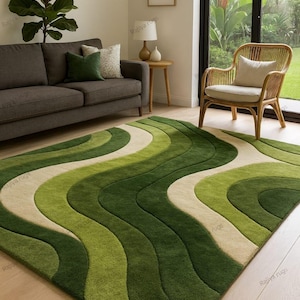 May include: A green and beige area rug with a wavy pattern dominates the room. The rug's design features alternating bands of light and dark green, and beige. The rug is placed in a living room setting, with a sofa, chair, and side table.