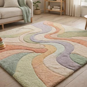May include: A large, rectangular area rug with a wavy, abstract design in pastel colors. The rug features shades of peach, green, lavender, and cream. A wooden stacking toy sits on the rug. The rug is on a hardwood floor.