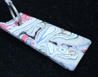 Fordite Pendant, white red yellow blue gray, silver colored jump bail 14ct; Fordite is dried paint from the plant spray paint booth