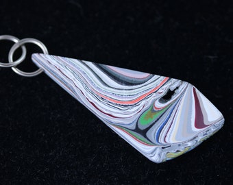 Fordite Pendant. white gray orange red green maroon light lavender, silver colored jumps bail 20.5ct