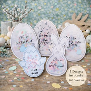 Puede incluir: Un conjunto de decoraciones de Pascua con forma de huevo y conejito, llenas de confeti colorido. Las decoraciones son blancas y presentan texto en alemán. La imagen también incluye el texto "5 Designs im Bundle PDF Download".