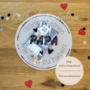 May include: A circular gift tag with the word "PAPA" in large black letters, surrounded by text and heart shapes. The tag contains a small card and confetti, with the words "PDF" and "Personalizable" visible.