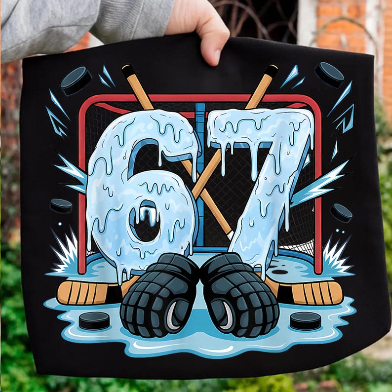 May include: Black graphic featuring a hockey-themed design. The number "67" is rendered in a dripping ice effect, set against a hockey net, sticks, pucks, and gloves. The design is set on a black background.