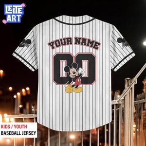 A white baseball jersey with a Mickey Mouse design and the text "YOUR NAME 00" printed on it.