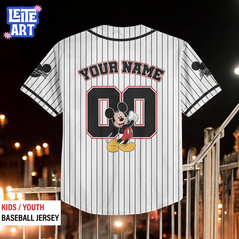 A white baseball jersey with a Mickey Mouse design and the text "YOUR NAME 00" printed on it.